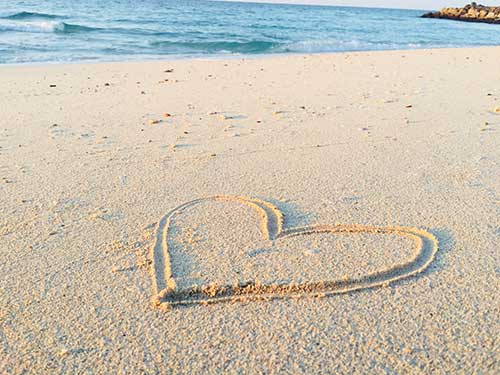 Heart drawn in the sand on a beach